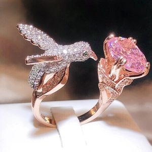 Macro shot of rose gold hummingbird ring with a large oval pink gemstone setting