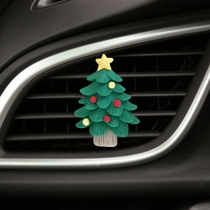 Cartoon Christmas tree air vent clip showing soft silicone texture on a car dashboard