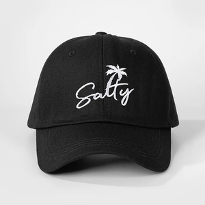 Close-up of Salty text and palm tree embroidery on the black cotton baseball cap