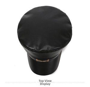 Top view of black faux leather captain hat featuring dual gold decorative metal chains