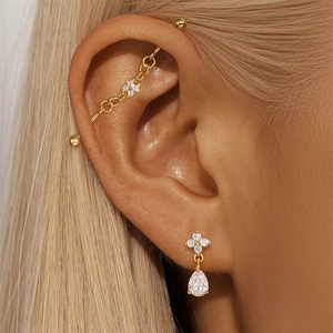 Detail of gold floral petal stud earrings with zircon waterdrop charms on model