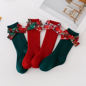 Christmas kids knee-high socks set with snowflakes and large plaid bows in red and green
