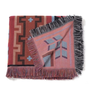 Detail of bohemian geometric woven blanket with tassels and thick textured ethnic pattern