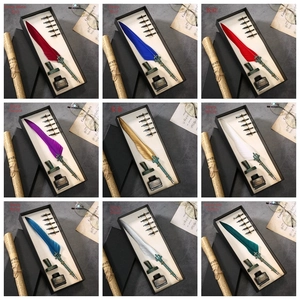 Detail of vintage feather quill pen sets in nine colors with nibs and wax seal stamp