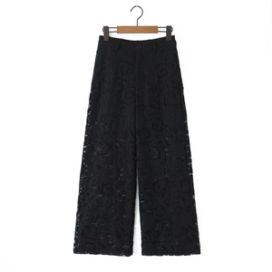 Elegant women's black lace wide-leg trousers featuring detailed hollow flower patterns