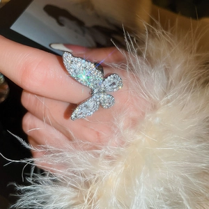 Macro shot of silver ring featuring a detailed butterfly design encrusted with sparkling cubic zirconia