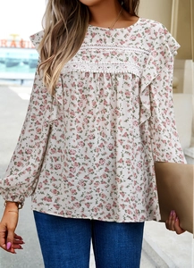 Close-up of floral print blouse with lace trim, ruffles, and cotton linen texture