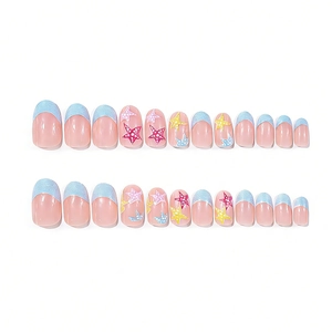 Short oval press-on nails with blue glitter French tips and colorful star patterns