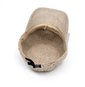 Detail of oatmeal knitted baseball cap interior with adjustable black drawstring fastener