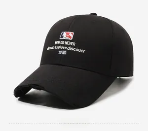 Close-up of black cotton baseball cap featuring vintage embroidery and distressed brim edge