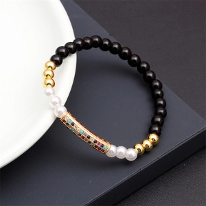 Macro shot of colorful zircon tube bead bracelet with matte tiger eye and pearl stones