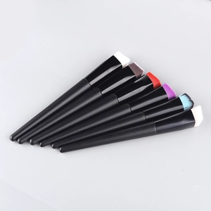 Detail of 7-piece makeup brush set with colorful angled bristles and black matte handles