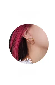 Detail showing 18k gold heart-shaped earrings with textured bamboo surface pattern