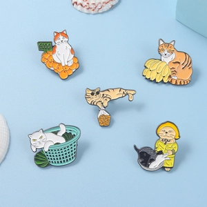 Detailed view of creative cat enamel pins with colorful fruit and raincoat designs