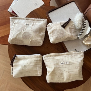 Detail of minimalist cotton linen cosmetic bags with textured pattern and zipper closure