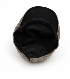 Detail view of newsboy cap featuring brown woven texture and black fabric lining