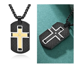 Close-up of black carbon fiber dog tag with gold cross and diamond on metal chain