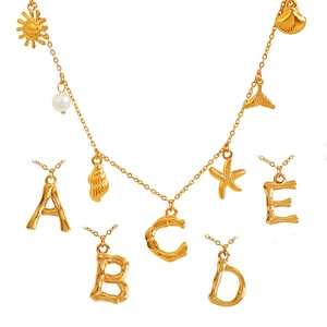 18K gold plated titanium necklace with ocean pendants and bamboo style initial charms