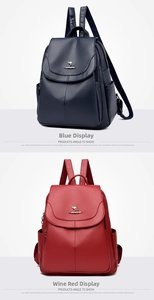 Detailed view of navy blue and wine red pebbled leather backpacks with kangaroo metal logos