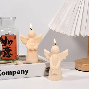 Detailed view of angel scented candles holding heart and star for home decor