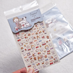 Detailed view of thin cartoon puppy nail stickers with cake and glasses patterns