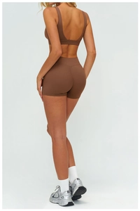Rear view of high-waist scrunch butt yoga shorts and sports bra in dark brown set