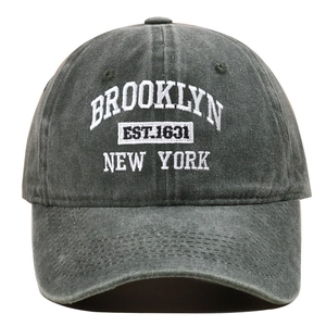 Detail of Brooklyn embroidery on washed cotton grey baseball cap with 3D stitching