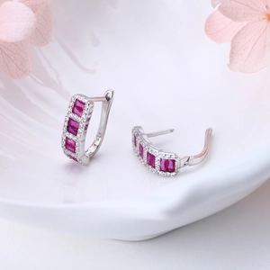 Macro shot of S925 sterling silver hoop earrings with red rectangular stones and zircons