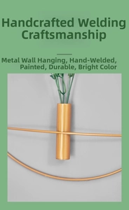 Close-up of golden iron wall-mounted vase with handcrafted welding and spray-painted finish