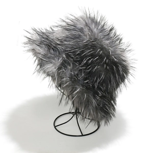 Detailed view of fluffy grey faux fox fur bucket hat on a black metal frame stand