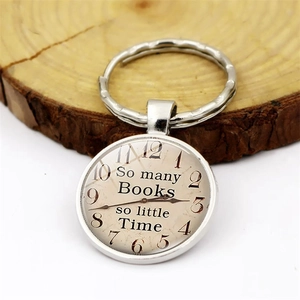 Vintage So Many Books So Little Time clock pendant keychain on a wooden background