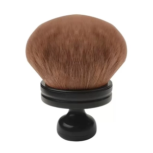 Close-up of fluffy brown bristles and ergonomic handle on a large multipurpose powder brush