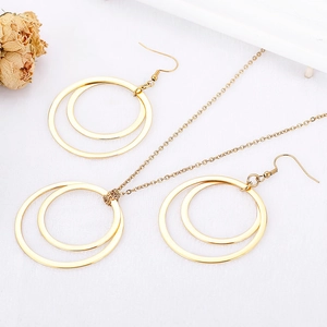 Golden geometric interlocking circles necklace and earrings set on white fabric