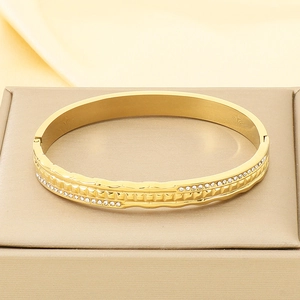 Close-up of luxury 18K gold plated stainless steel bangle with double row of pavé crystals