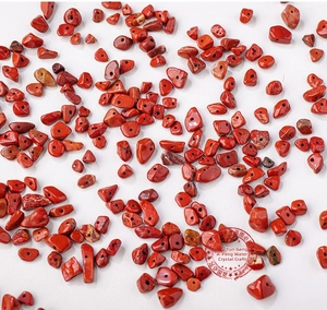 Macro shot of irregular red jasper gemstone beads with pre-drilled holes for DIY jewelry