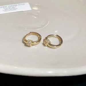 Close-up of 18k gold plated hoop earrings with micro-pave cubic zirconia charms