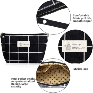 Detail view of large canvas makeup bag with grid pattern, internal dividers and smooth zipper