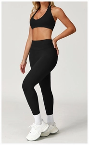 Detailed view of black halter sports bra and high-waisted yoga leggings outfit