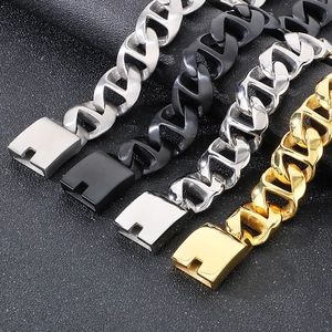 Macro detail of Cuban chain bracelets in matte silver, black, and polished gold finishes
