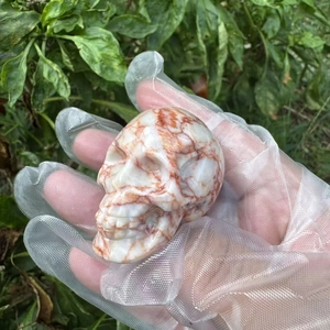 5cm hand-carved natural semi-precious stone skull with red and white quartz texture