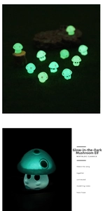 Close-up of luminous mushroom sprite figurines glowing green in dark micro landscape