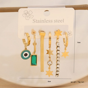 Detail of 6-piece gold stainless steel earring set with evil eye and clover charms