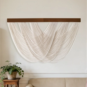 Bohemian hand-woven wall tapestry with multi-layer rope arcs and a dark wood rod