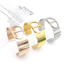 Detail of three-color minimalist bangle set featuring a signature hollow CD design