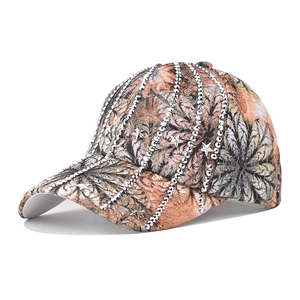 Detailed view of floral baseball cap with rhinestone lines and star metal rivets