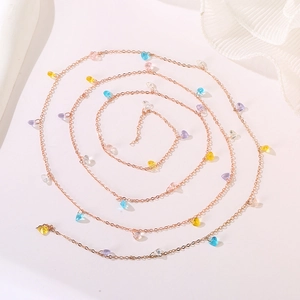 Artistic spiral view of rose gold necklace with colorful heart-shaped crystal charms