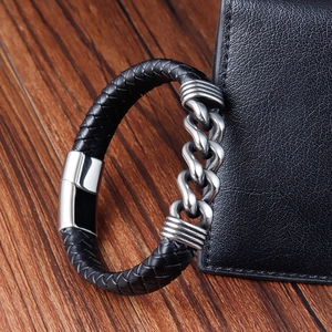 Close-up of men's braided leather bracelet with stainless steel chain and magnetic clasp