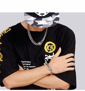 Silver cuban chain necklace and bracelet set shown on male model with urban street style