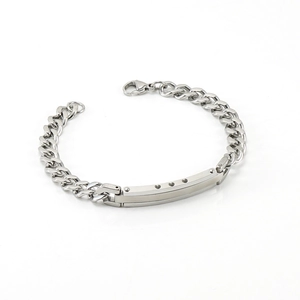 Three-tone stainless steel Cuban bracelet with heart-cutout ID plate on white background