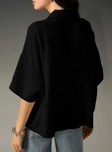 Back view of a women's black short sleeve shirt showing loose fit and soft drape detail